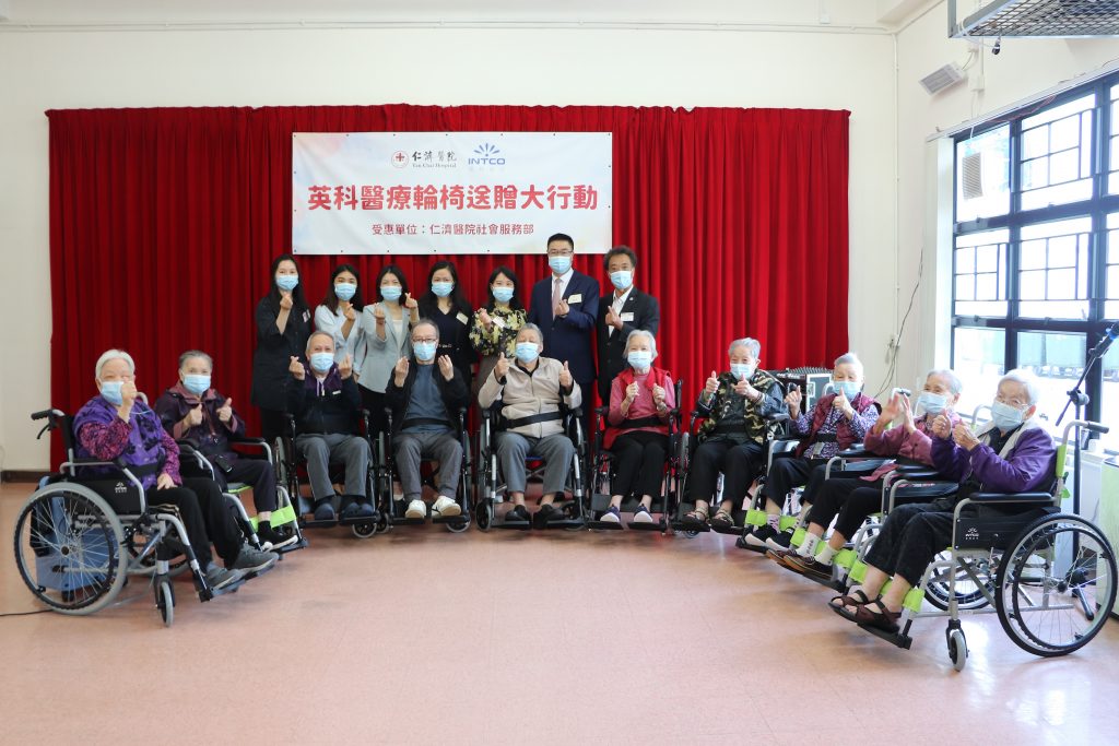 The old man sits in a wheelchair donated by INTCO