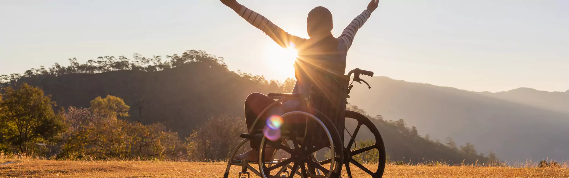 A person is sitting in a manual wheelchair.