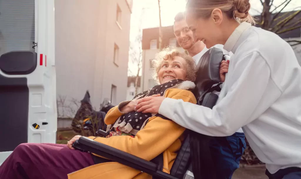 A man and a woman are helping the elderly get on the car.