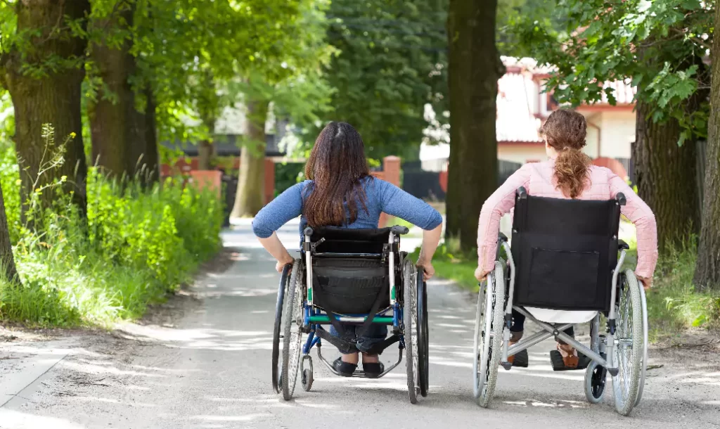 Two women were sitting in wheelchairs.