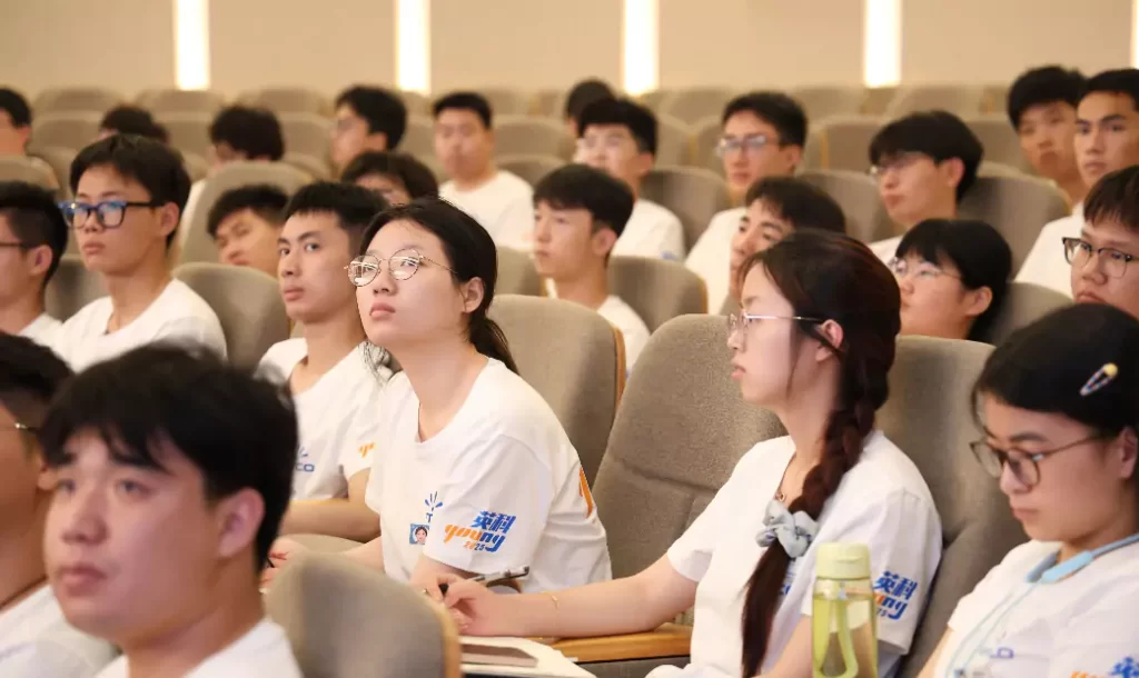 The partners listening attentively in the audience
