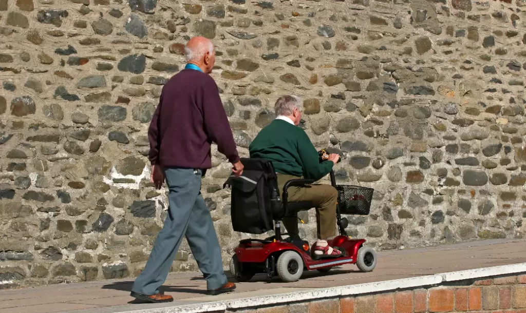disabled-elderly-man-riding-mobility-vehicle