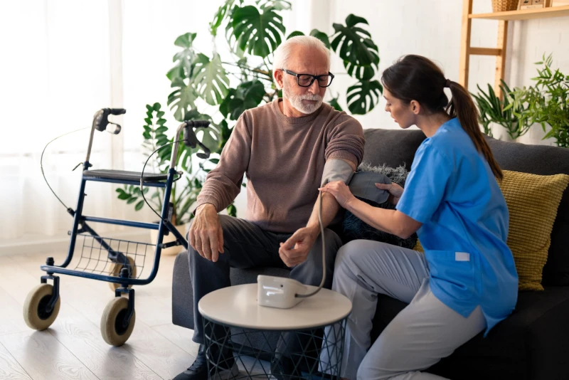 Measure the blood pressure of the elderly person
