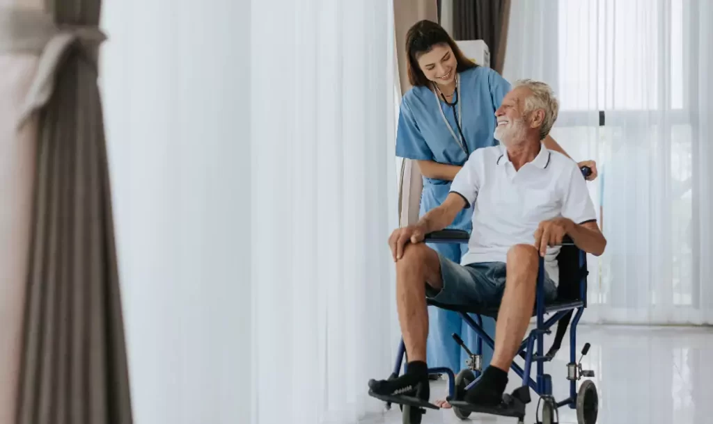 Young asian nurse helping senior man at home.